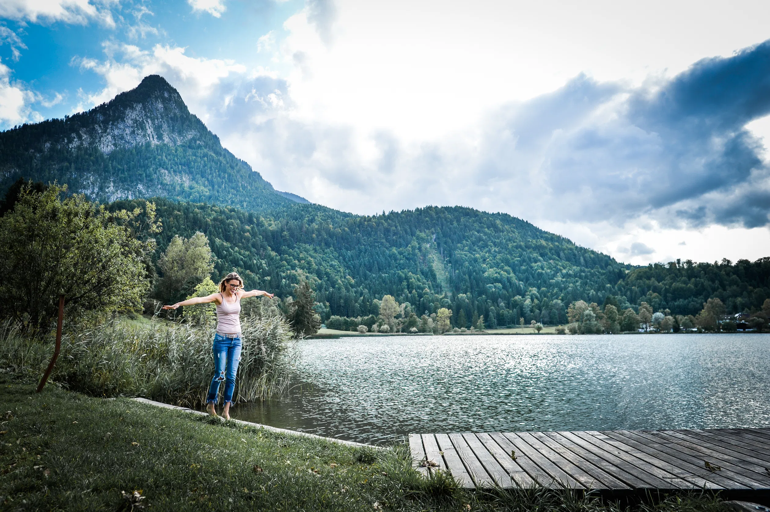 Woman enjoying her life by the lake with a mountain view