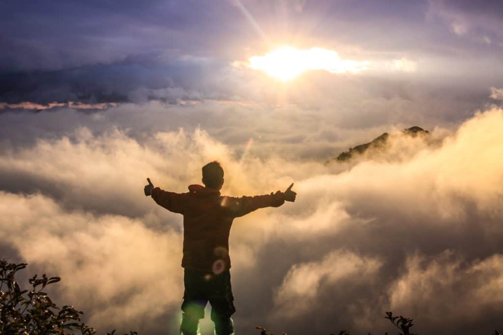 Man spreads arms and celebrates the universe