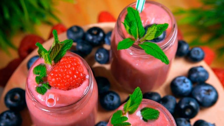 Berry smoothies decorated with fresh berries and mint