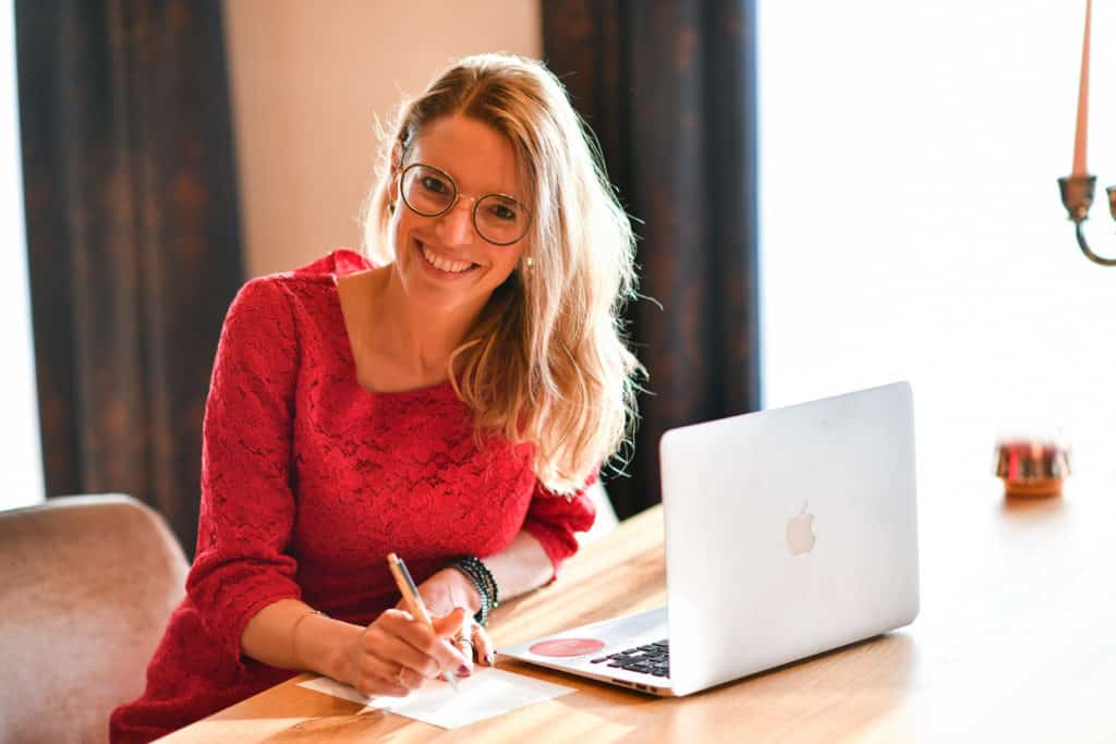 A woman at a computer enjoying her daily job routine